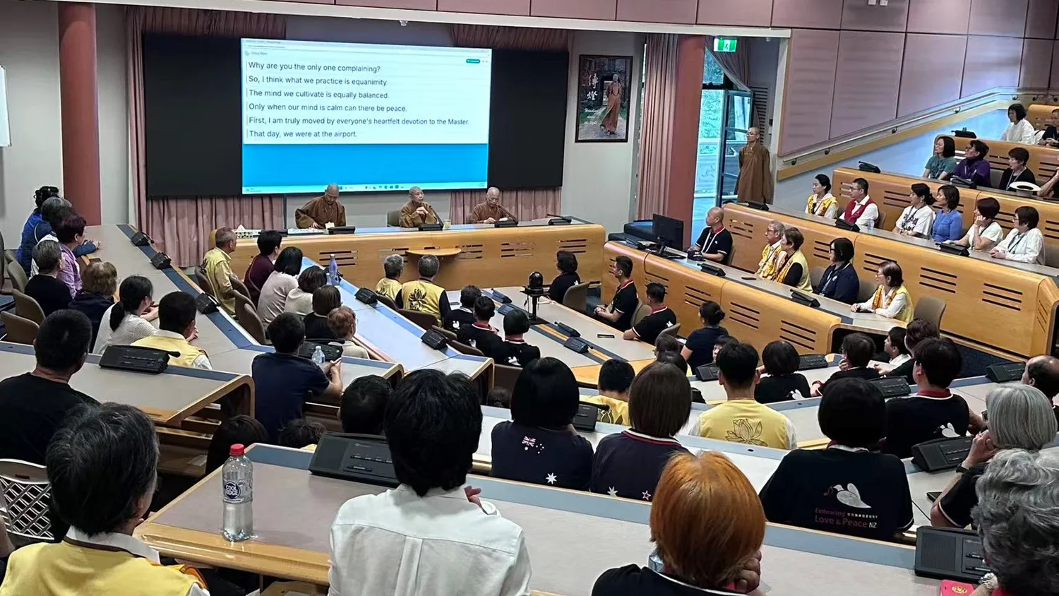 A congregation at an overseas Fo Guang Shan chapter following a teaching on the room’s live captions.