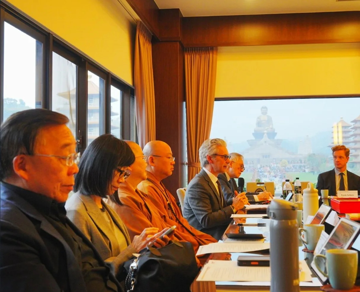 A guest lecture at the Fo Guang Shan Buddha Museum, iPads at each seat and the Great Buddha visible through the window.